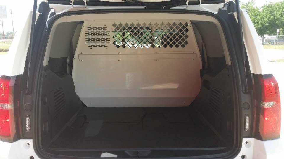 Police vehicle interior fitted with a secure partition separating the front and rear compartments