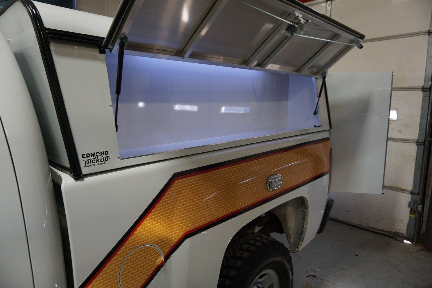 Emergency response vehicle displaying high-visibility reflective graphics and safety markings