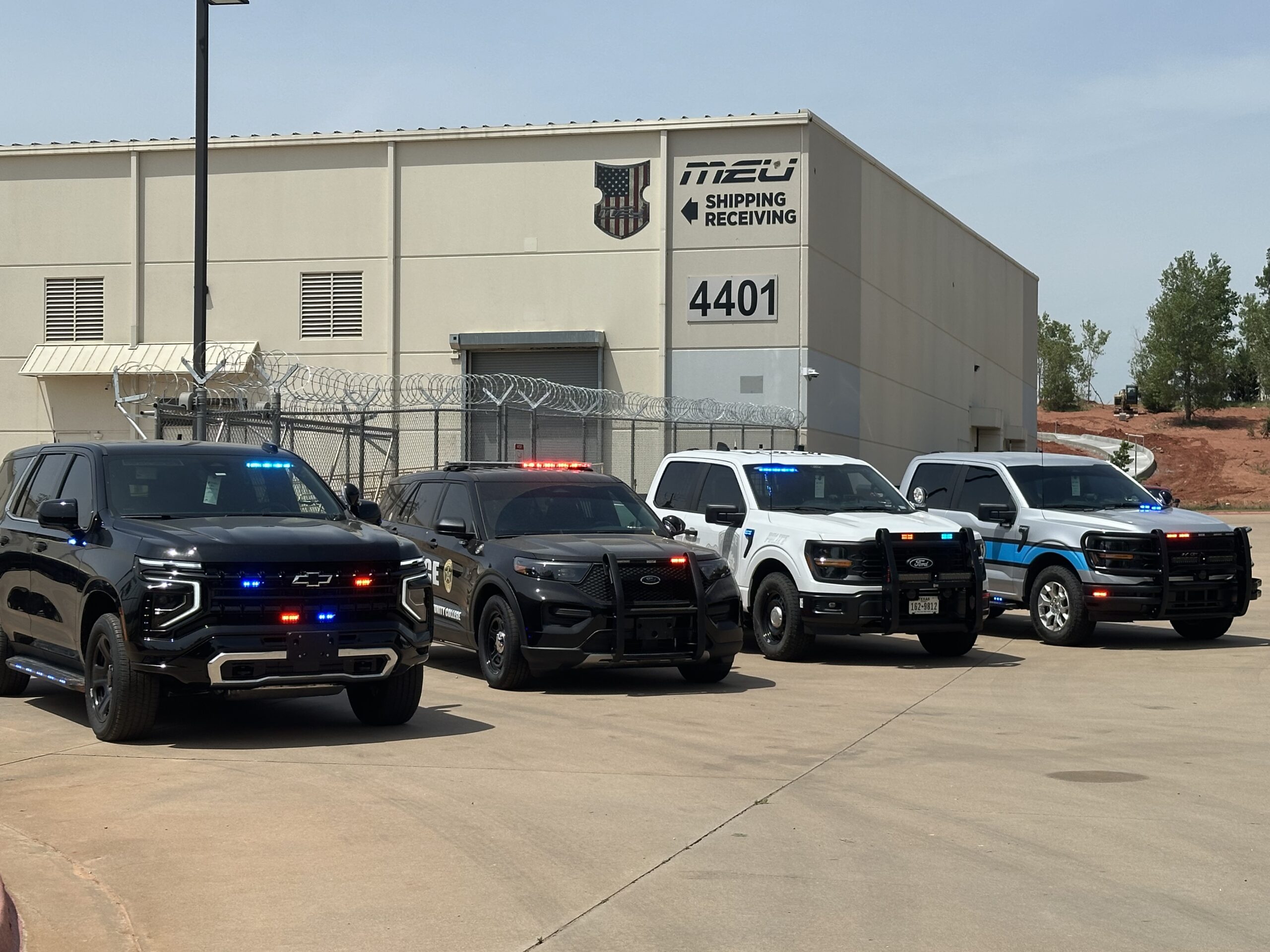 Tahoe, Police Interceptor Utility and F-150 vehicles staged for custom upfitting at Metro Emergency Upfitters