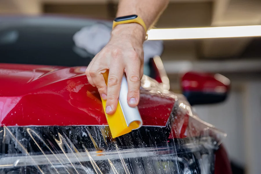 Paint protection film being professionally applied to a commercial vehicle