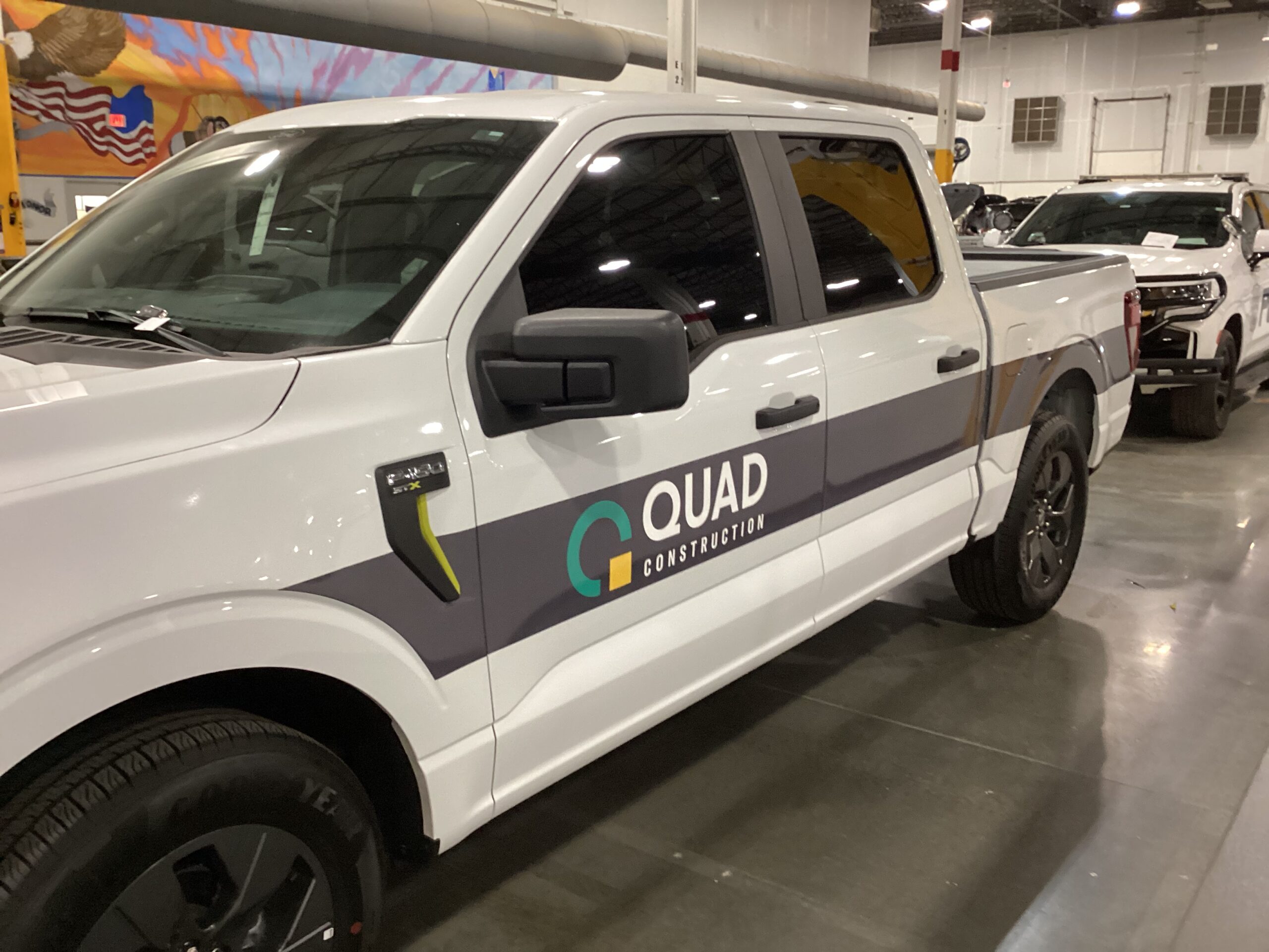 Commercial work truck with fleet graphics completed by Metro Emergency Upfitters