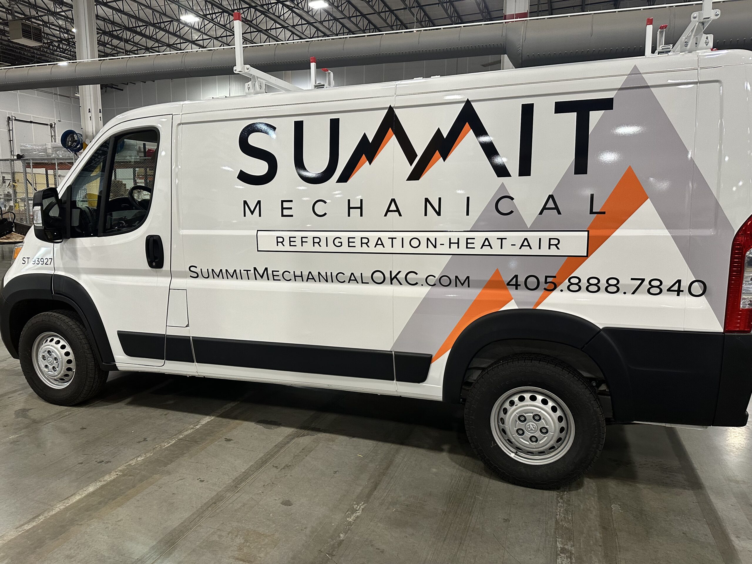 Commercial work van with Summit branding and professional graphics completed by Metro Emergency Upfitters