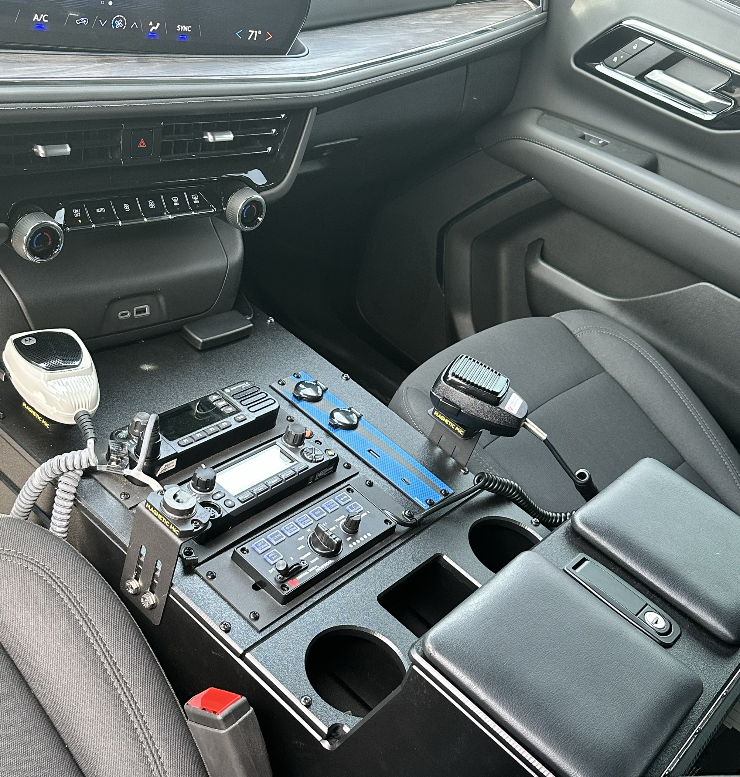 Patrol vehicle interior fitted with a center console and organized public safety equipment